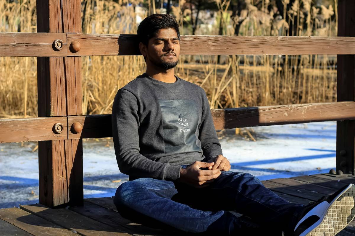 a man sitting on the bench and relaxing