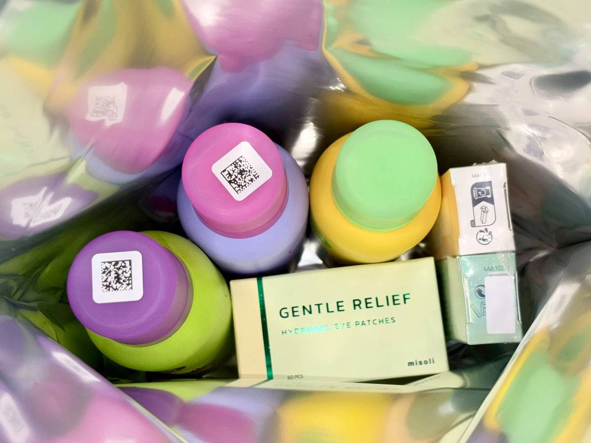 Colorful bottles and a box of patches inside a bag.