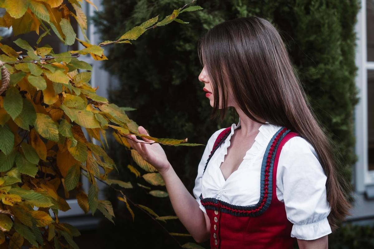 Woman in Red Dirndl with Autumn Leaves